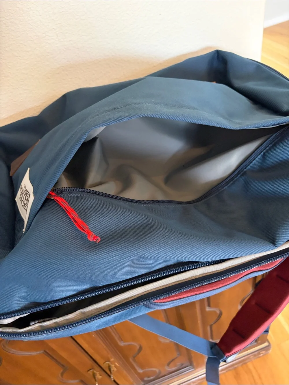 The North Face Travel Duffel Blue Backpack with Red Accents